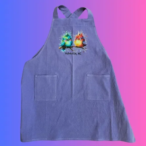 Child’s Apron Purple Cotton Cross Back Cute Birds Asheville, NC logo